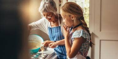 grandmother and granddaughter baking together