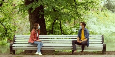 man and woman on socially distanced date in the park