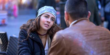 woman who is giving up on her boyfriend looking at him across a table