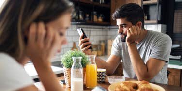 couple on phones ignoring each other at breakfast table