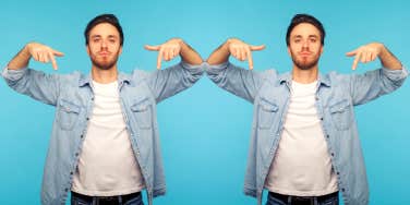 arrogant man pointing to himself in front of blue background