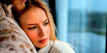 woman hugging man feeling unsure if she is still in love