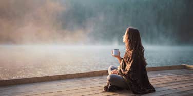 Woman sitting in nature, in her own thoughts