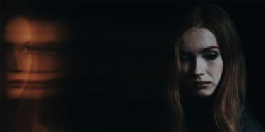 woman in dark shadow