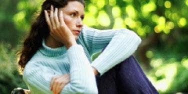 Woman on bench looking forlornly