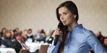 woman public speaking with a microphone