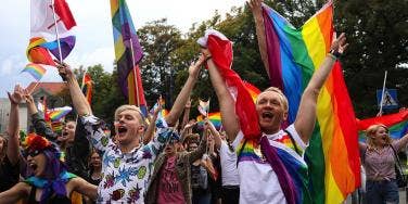 pride parade photo, young people with pride flags