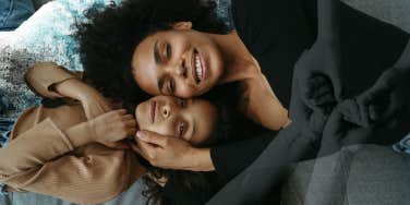 Mother snuggling her daughter