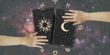 hands reaching for tarot cards