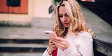 photo of woman looking at phone