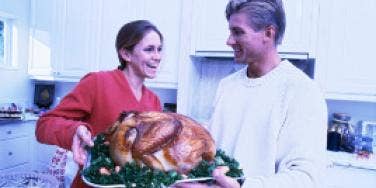 couple cooking the thanksgiving turkey