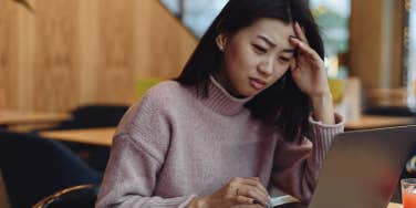 confused woman looking at laptop