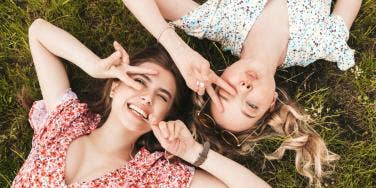 sisters laying on grass