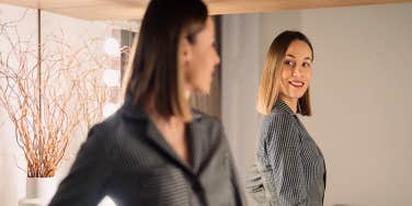 confident woman looking in the mirror
