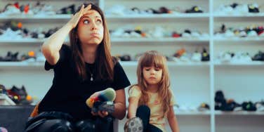mom and daughter try on shoes 