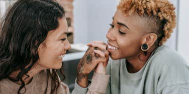 Couple holding hands staring into each others eyes