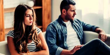 unhappy married couple sitting on a couch 