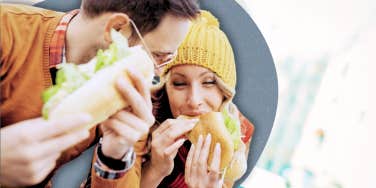 couple spending time together, eating a sandwich 