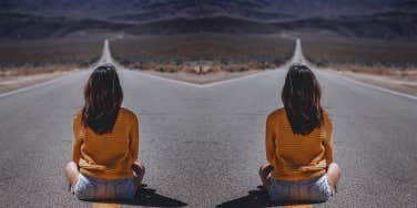 woman sitting on road