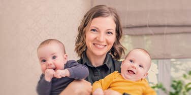 woman holding twin baby
