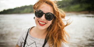 happy woman smiling wearing sunglasses