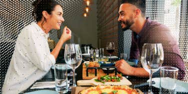 two people on a date eating pizza