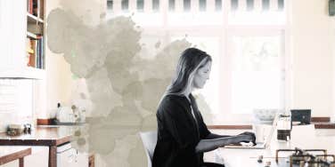 woman at kitchen island, scheduling her day