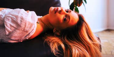 sad lonely woman laying on the couch