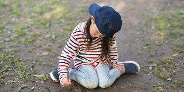 tomboy sitting on grass