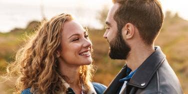 man and woman smiling at each other