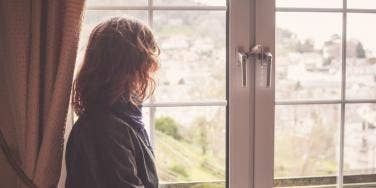 woman looking out window