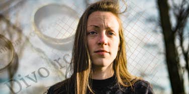 Woman standing, staring worried 