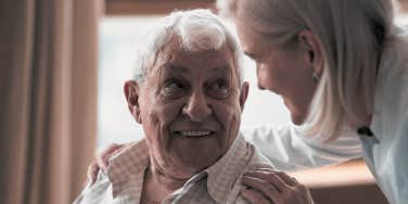 Woman embracing elderly man