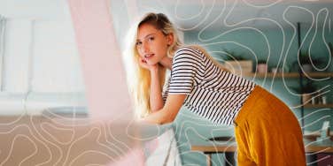 Happy woman leaning over railing