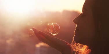 woman wishing on bubbles