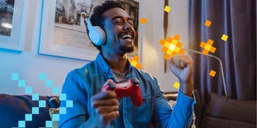 man playing video games and happy