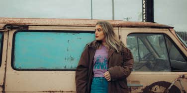 Woman standing in front of bus 