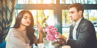 woman rejecting flowers from her man