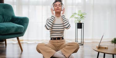 woman sitting alone listening to headphones