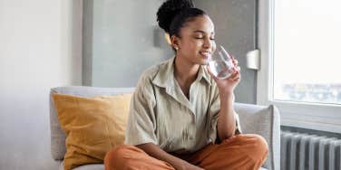 woman drinking water to calm anxiety