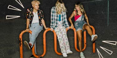 Friends hanging out on bike rack