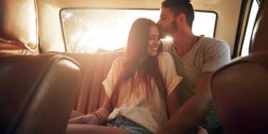 couple in car backseat snuggling