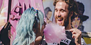 man feeding woman cotton candy