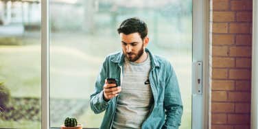 man on his phone anxiously waiting for a text