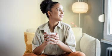 Woman drinking coffee staring out