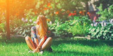 woman sitting in grass