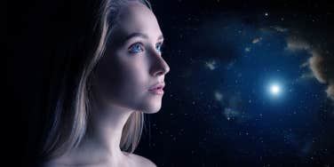 hopeful woman with universe behind her