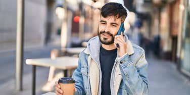 man on phone drinking coffee