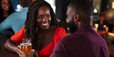 man and woman talking on date