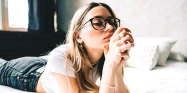 woman thinking on bed